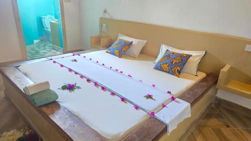 a large bed with decorations on it in a room at The Gale House in Umbuji