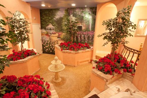 a flower shop with red flowers and potted plants at Destinations Inn Theme Rooms in Idaho Falls