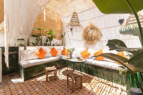 a room with a couch and a table and plants at Charm and Calm - Superbe appartement de luxe - Dahomy Beach - Bahia Beach in Bouznika