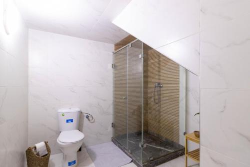 a bathroom with a toilet and a glass shower at Charm and Calm - Superbe appartement de luxe - Dahomy Beach - Bahia Beach in Bouznika