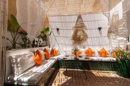 a white bench with orange pillows on a balcony at Charm and Calm - Superbe appartement de luxe - Dahomy Beach - Bahia Beach in Bouznika