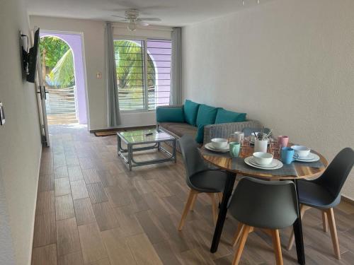 a living room with a table and a couch at Casa SaasNá, Departamento B, C y D in Cedro