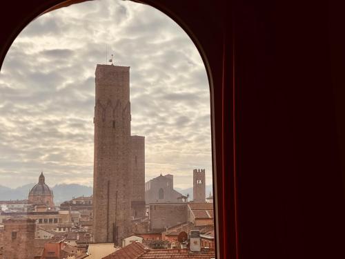 a window view of a city with a tall tower at Tower of Lovers - Ancient Altana in Bologna