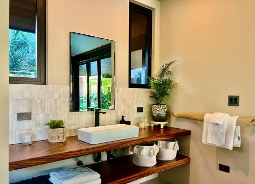 a bathroom with a sink and a mirror at Balinese Inspired Luxury Villa in Playa Avellana