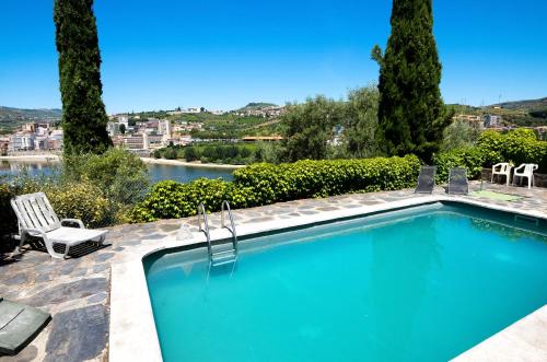 uma piscina com vista para um rio em Villa dos Pingueis em Lamego