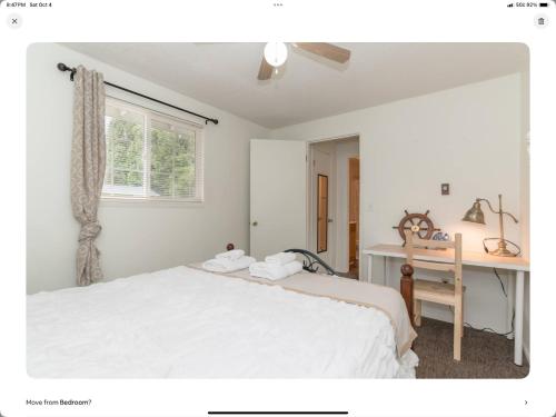 a bedroom with a bed and a desk and a window at Cozy, Charming & Central in Kent in Kent