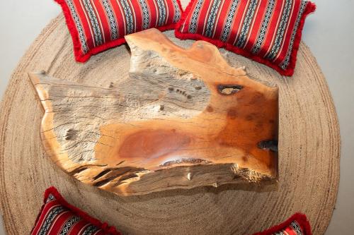 a wooden table topped with a wooden cutting board at Al Jalilain Inn in Nizwa