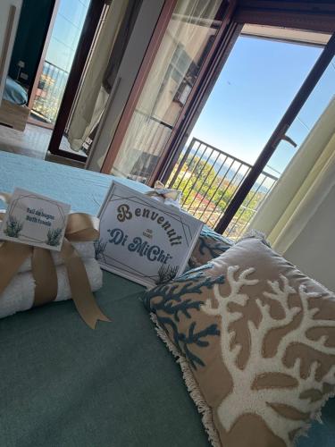 a bedroom with a bed with two pillows and a window at Home Capri in Torre del Greco