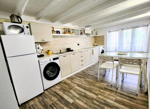 Una cocina con refrigerador y una mesa con sillas. en Don Vito's Home, DsG2 Short Lets, 250 mt Metrò, en Palermo