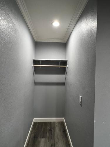 a room with a empty closet with a shelf at Aqua Inn Motel in El Monte