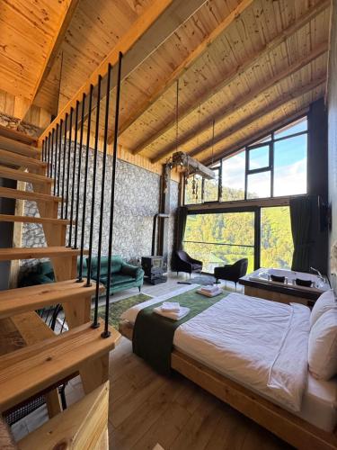 a bedroom with a bed in a room with wooden ceilings at Bucci Suit in Çamlıhemşin