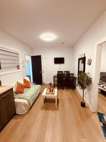 a living room with a couch and a table at Sweet home 2 bedroom suite in Surrey