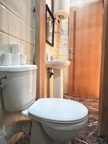 a bathroom with a toilet and a sink at La Pause Comfort style in the center in Temara