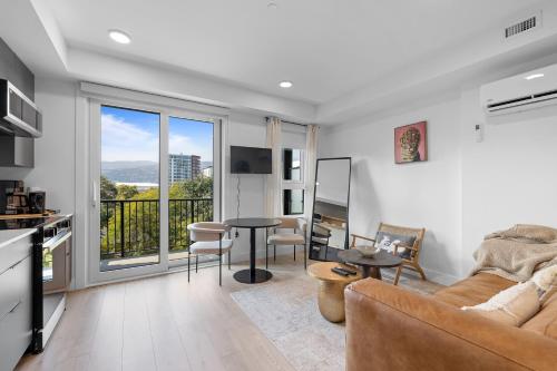 a living room with a couch and a table at Brand new suite downtown Kelowna - walk everywhere! in Kelowna