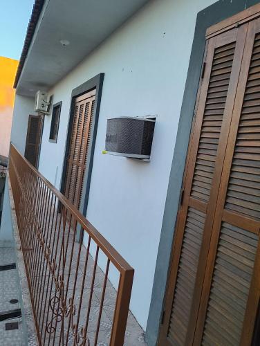 a house with a balcony with a fan on the wall at Não possui in São Gabriel