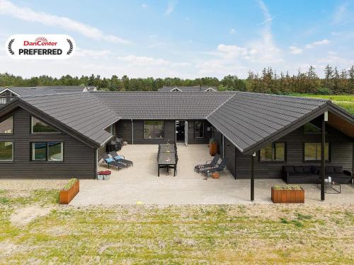 a house with a large patio in front of it at 20 person holiday home in Nørre Nebel in Nørre Nebel