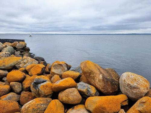 a pile of rocks on the shore of the water at Luxury Pool Villa in Lohals - By Traum Ferienwohnungen in Hou