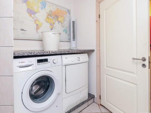 a laundry room with a washing machine and a map at 6 person holiday home in Thisted in Thisted