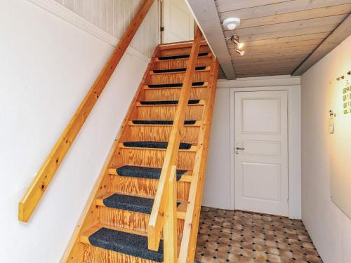 a staircase in a tiny home with wooden rails at 6 person holiday home in Thisted in Thisted