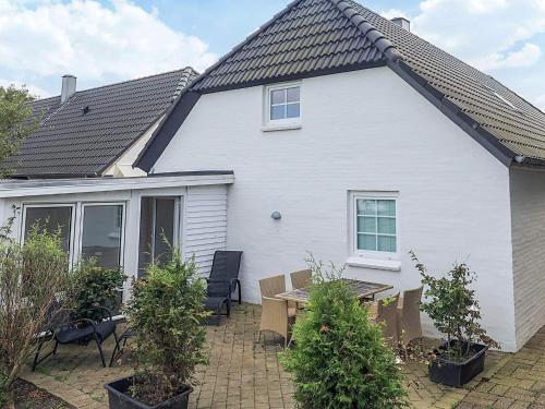 a white house with a table in front of it at 6 person holiday home in Thisted in Thisted