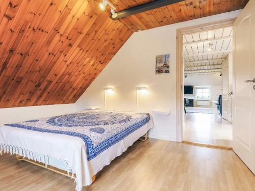 a bedroom with a bed and a wooden ceiling at 6 person holiday home in Thisted in Thisted