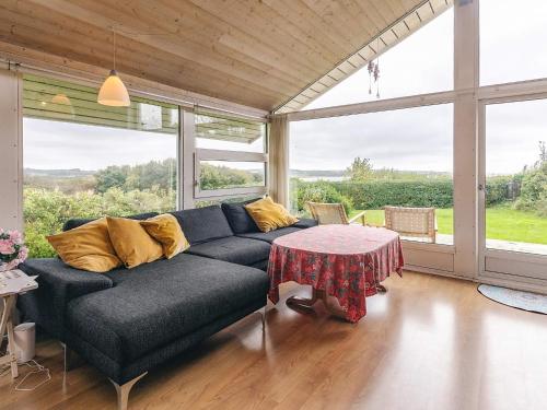 a living room with a couch and a table at 4 person holiday home in Struer in Struer