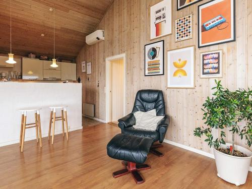 a black leather chair in a room with a counter at 4 person holiday home in Struer in Struer