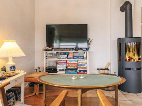 a living room with a table and a fireplace at 4 person holiday home in Struer in Struer