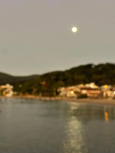 a blurry picture of a body of water with a moon at Recanto Praia das Vieiras in Porto Belo