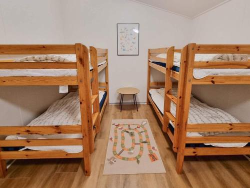 a room with three bunk beds and a rug at Spacious Retreat by Limfjorden - By Traum Ferienwohnungen in Sillerslev