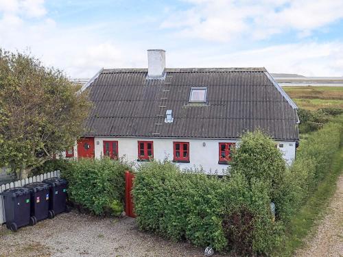 a white house with red windows and a black roof at Panoramic View Fisherman's House - By Traum Ferienwohnungen in Vesløs