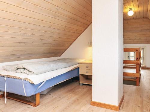 a bed in a room with a wooden ceiling at Panoramic View Fisherman's House - By Traum Ferienwohnungen in Vesløs