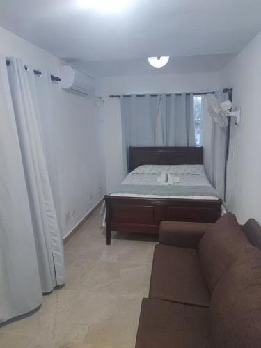 a living room with a bed and a couch at Samana house in Santa Bárbara de Samaná