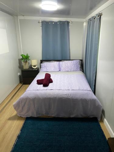a bedroom with a bed with a red stuffed animal on it at Secret Bay Hideaway in Fishing Point