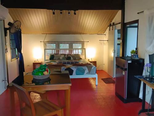 a bedroom with a bed and a table in a room at Koh Mak 9 in Ko Mak