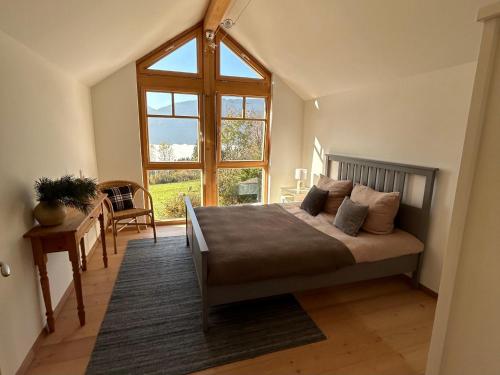 a bedroom with a bed and a large window at Landhaus St Georgen im Gailtal in Emmersdorf