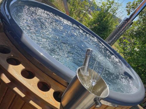 a bath tub with a glass of wine in it at Bavaria in Teunz
