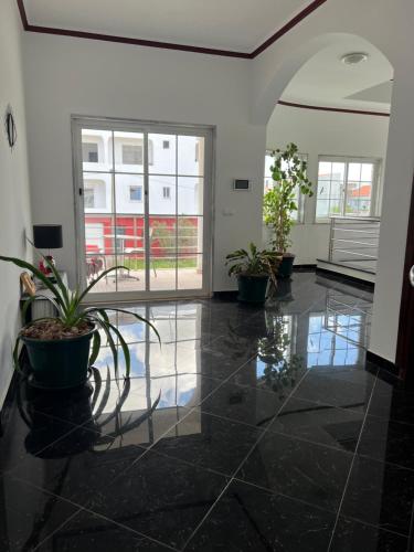 a hallway with potted plants in a building at Casa Miami in Tarrafal