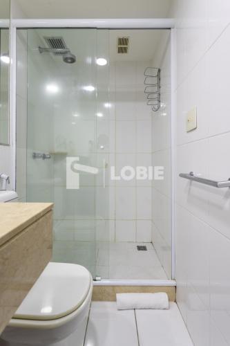 a white bathroom with a shower and a toilet at Lobie Botafogo Privilege in Rio de Janeiro
