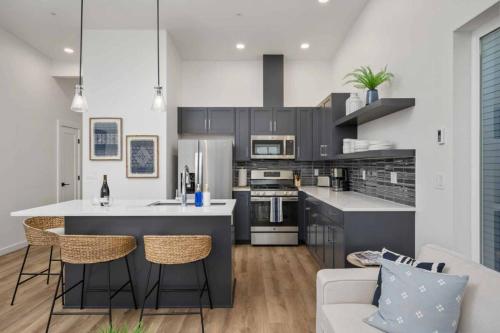 a kitchen with a large island in a living room at Ebb916 Modern Loft, Heart of Taft District, Walkable to Beach in Lincoln City
