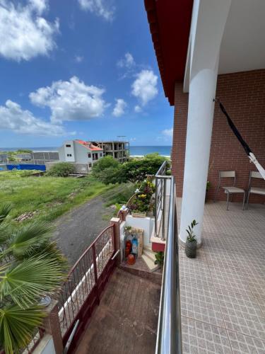 a balcony of a house with a view of the ocean at Casa Miami in Tarrafal