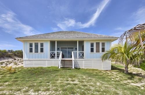 a house on the beach with a palm tree at Bohemia Two Bedroom home in James Cistern