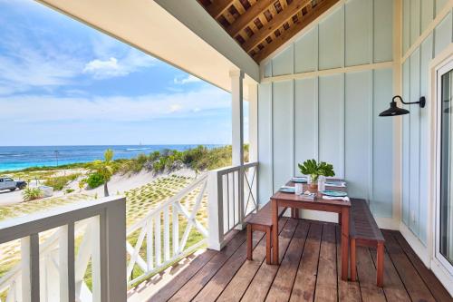 a balcony with a table and a view of the beach at Bohemia Two Bedroom home in James Cistern