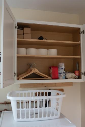 a cupboard with bowls and a basket in a kitchen at The Nautilus at JS Hubbs Guest House in Hammondsport