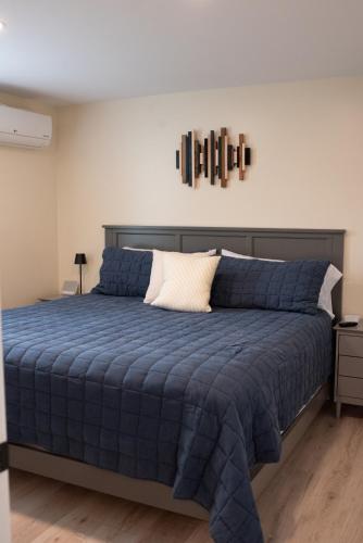 a bedroom with a blue bed with a blue comforter at The Nautilus at JS Hubbs Guest House in Hammondsport