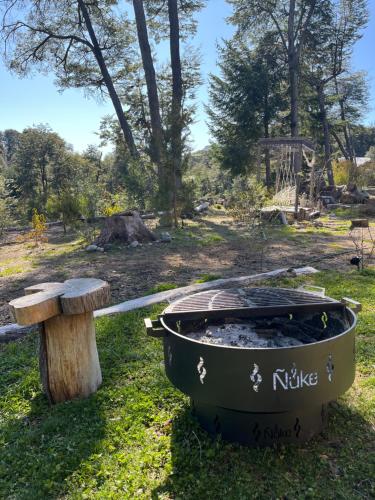 a bath tub sitting next to a wooden bench at CasaSur- 37Robles in Villa La Angostura