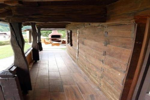 a hallway with a large wooden door in a house at Holiday Home Stara Murva - Three Bedroom Holiday Home with Patio in Tuheljske Toplice