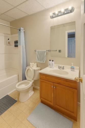 a bathroom with a toilet and a sink and a shower at Prime Location! 2BR-3BA Near WVU & Downtown Fun in Morgantown