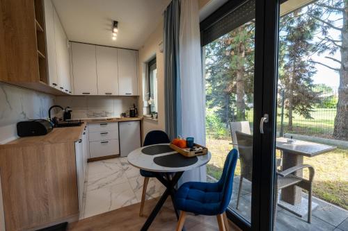 a kitchen with a table and chairs and a window at Rajska7712 in Wrocław