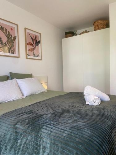 a bedroom with a bed with two towels on it at Studio Premium Haguenau in Haguenau